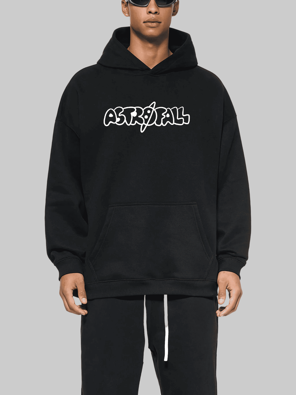 Person wearing a black hoodie with 'ASTROFALL' logo on a gray background