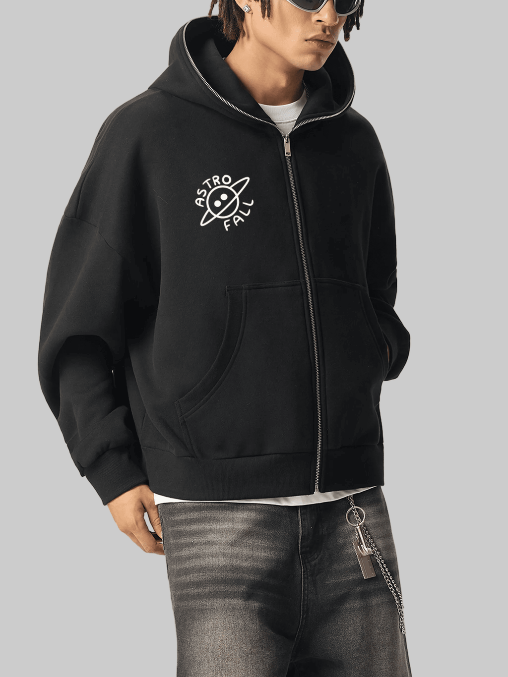 Person wearing a black hoodie with a logo on a gray background