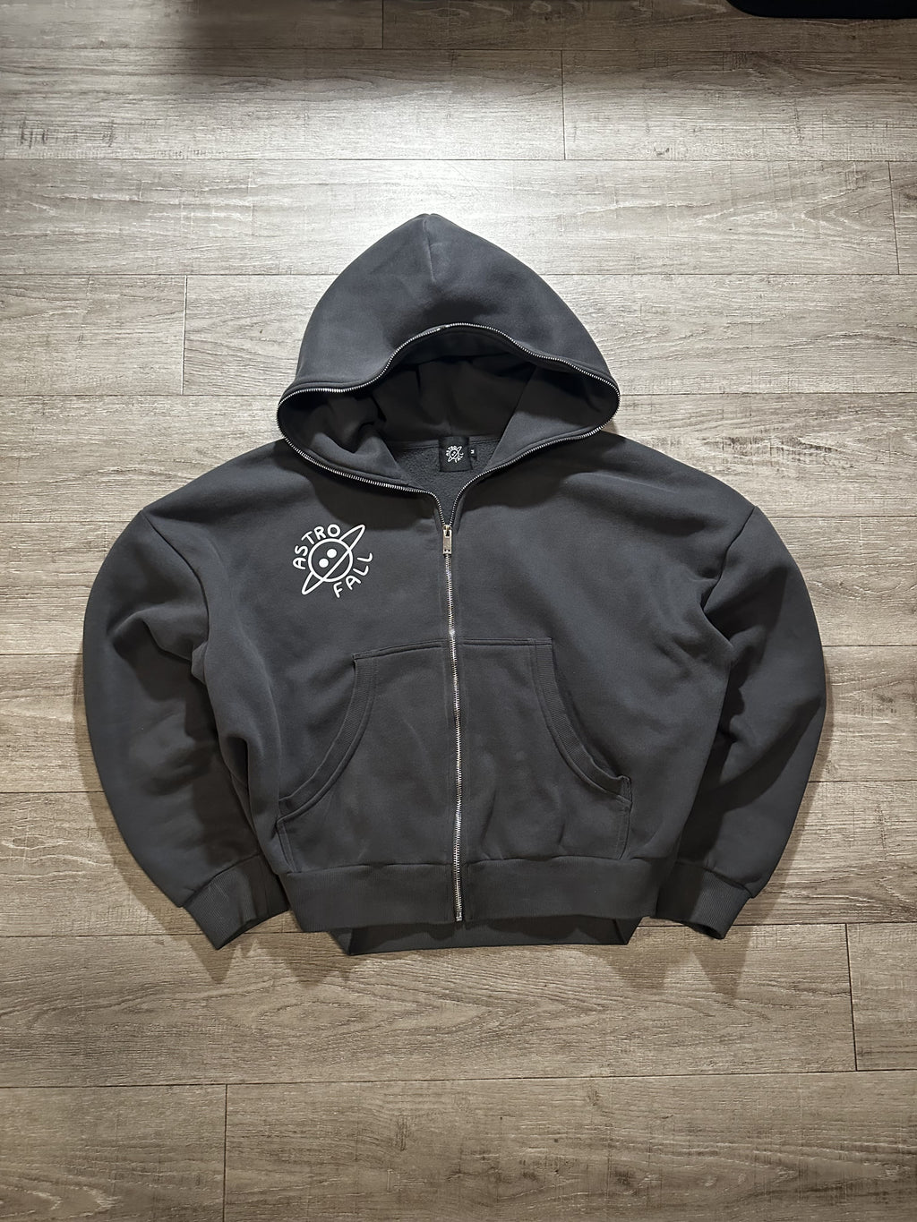 Full dark grey zipper with 'Astrofall' logo on the right.